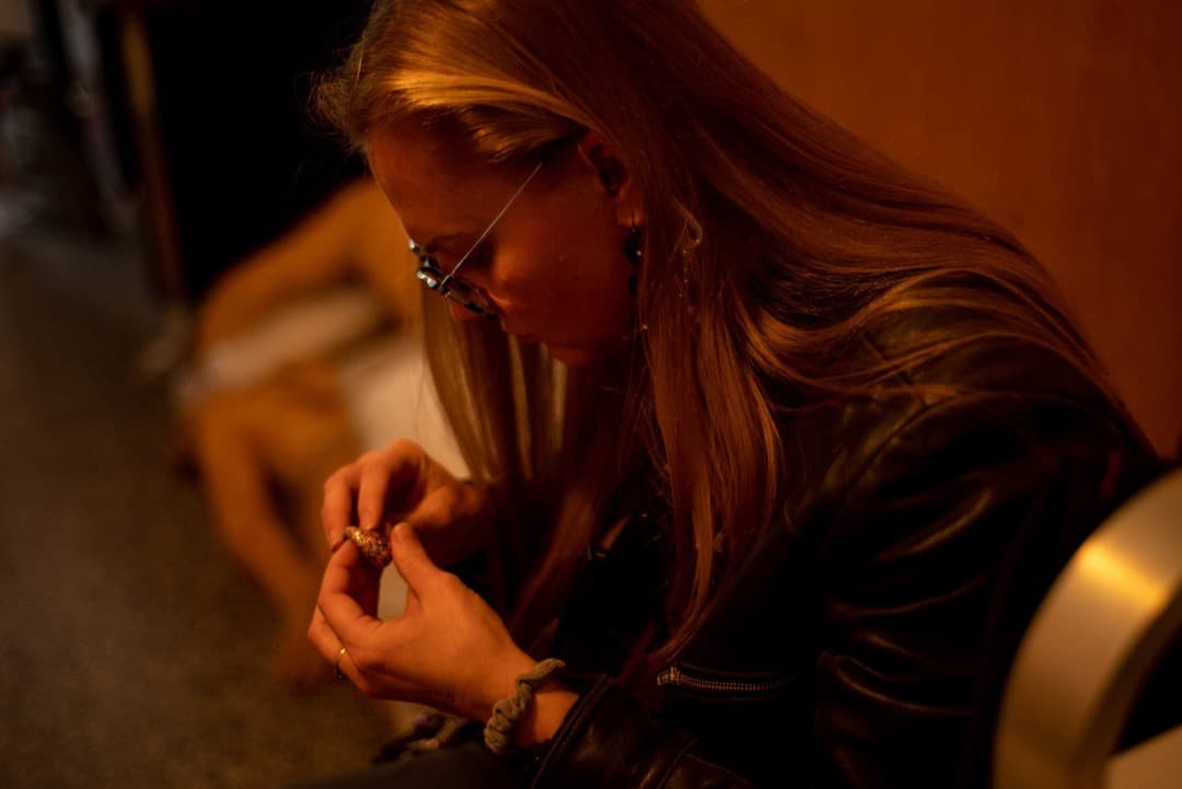 Behind the scenes photo 19 from Clone Cops production showing costume designer hannah schmidt working on a custom piece of jewelry